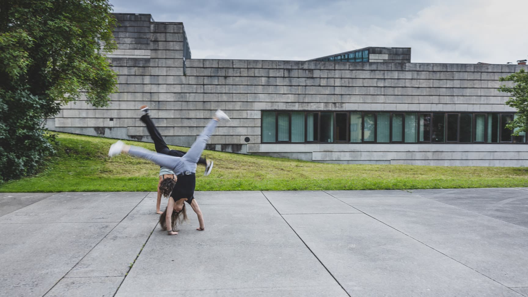 Zwei Jugendliche schlagen ein Rad.